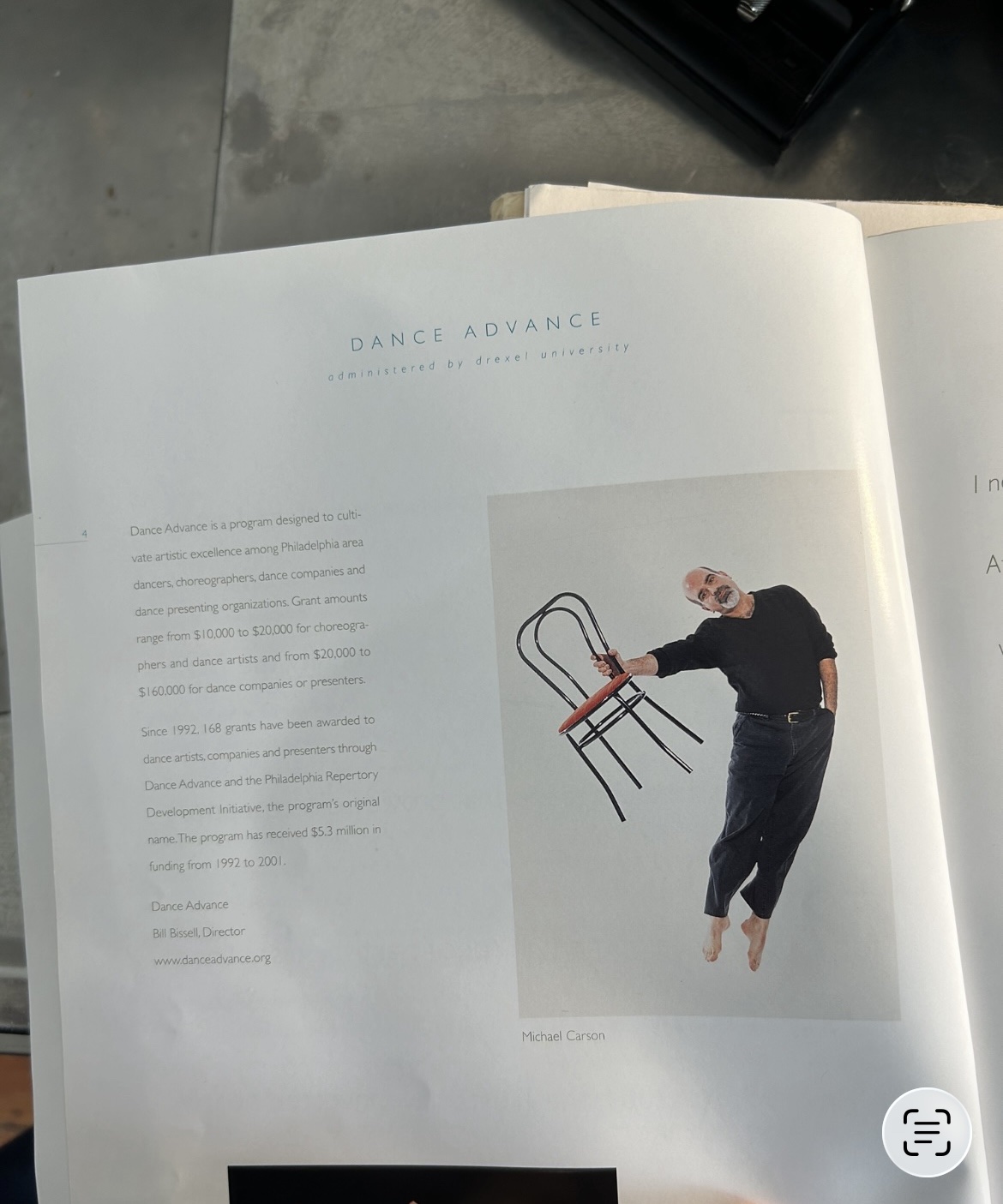 Dance Advance program page with a color photograph of Michael Carson mid-leap holding a chair